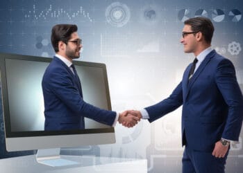Telepresence concept with two businessman handshaking